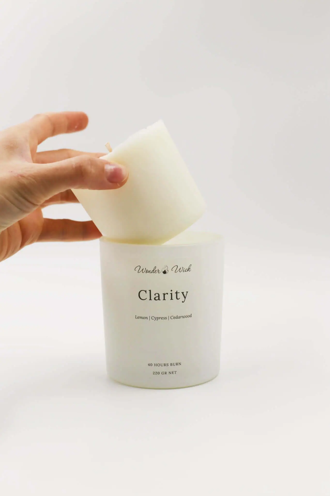 Placing a Clarity candle refill into its House of Gandha jar
